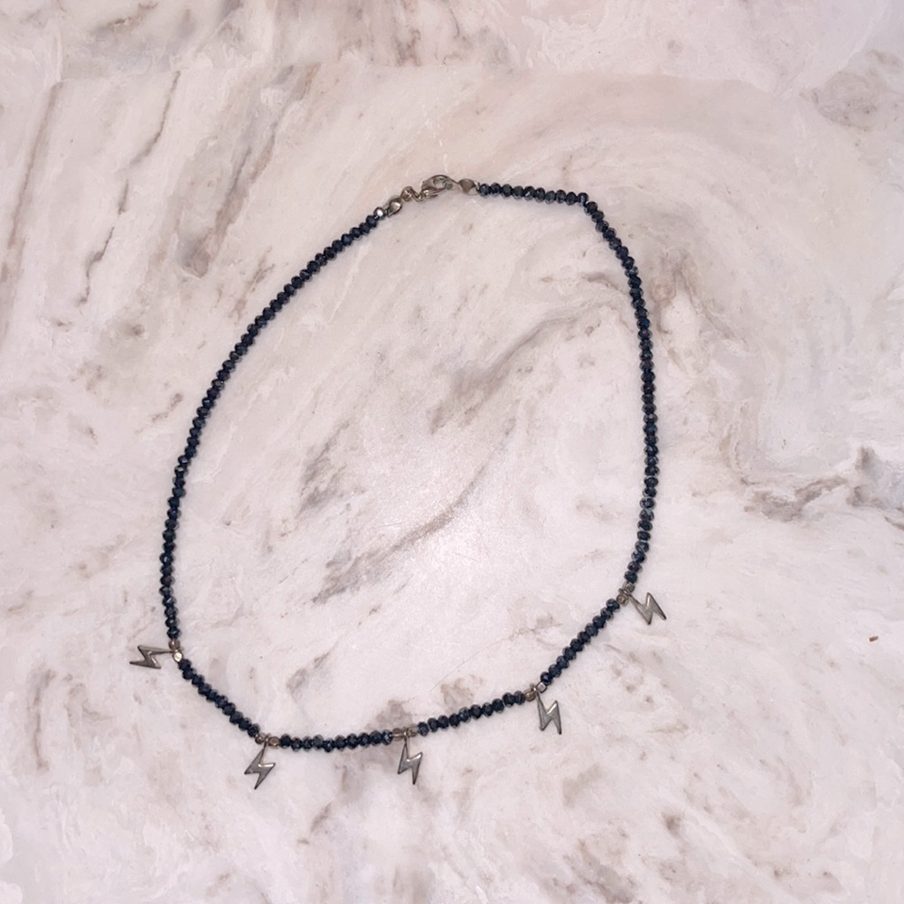 Dark navy blue, with lightning bolt chocker.